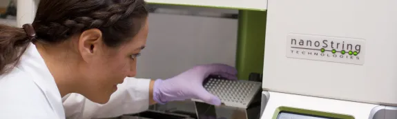 Female scientist loads instrument